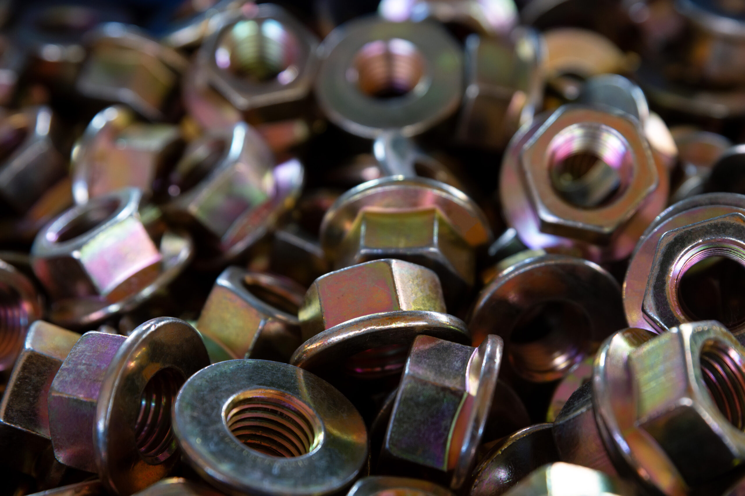 Close-up glossy brass nuts background. Brand new stainless screws or fastener. Industrail abstract concept